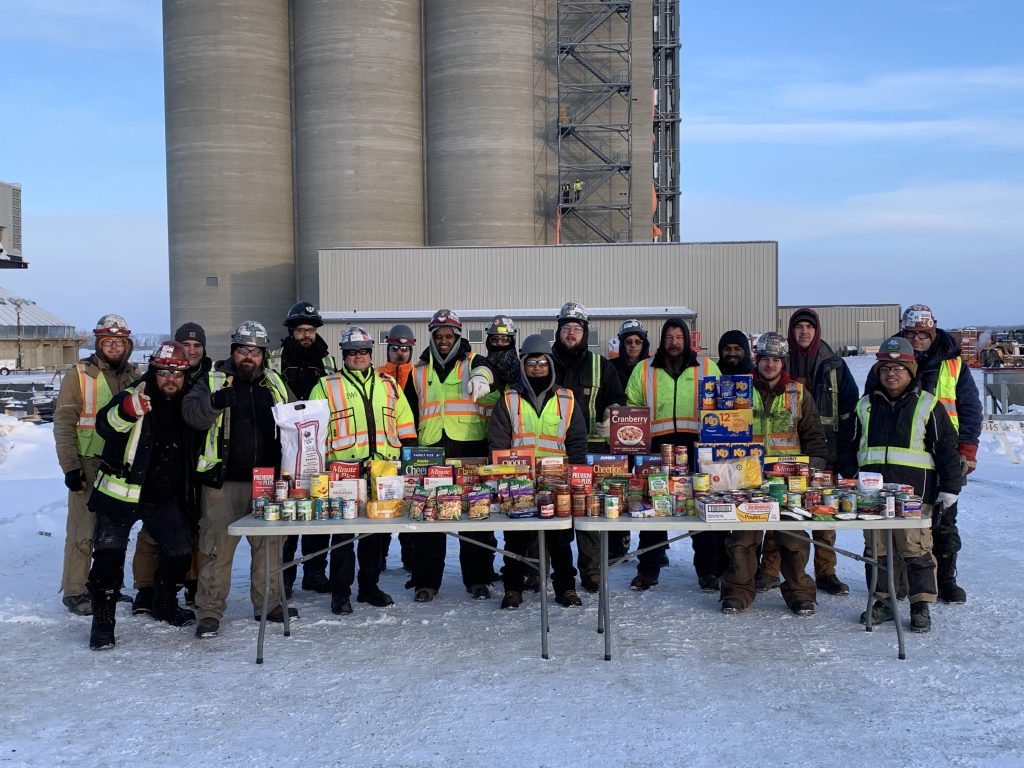 Field crew posing with non-perishable food items 